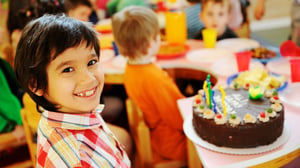 Children at birthday party with cake.